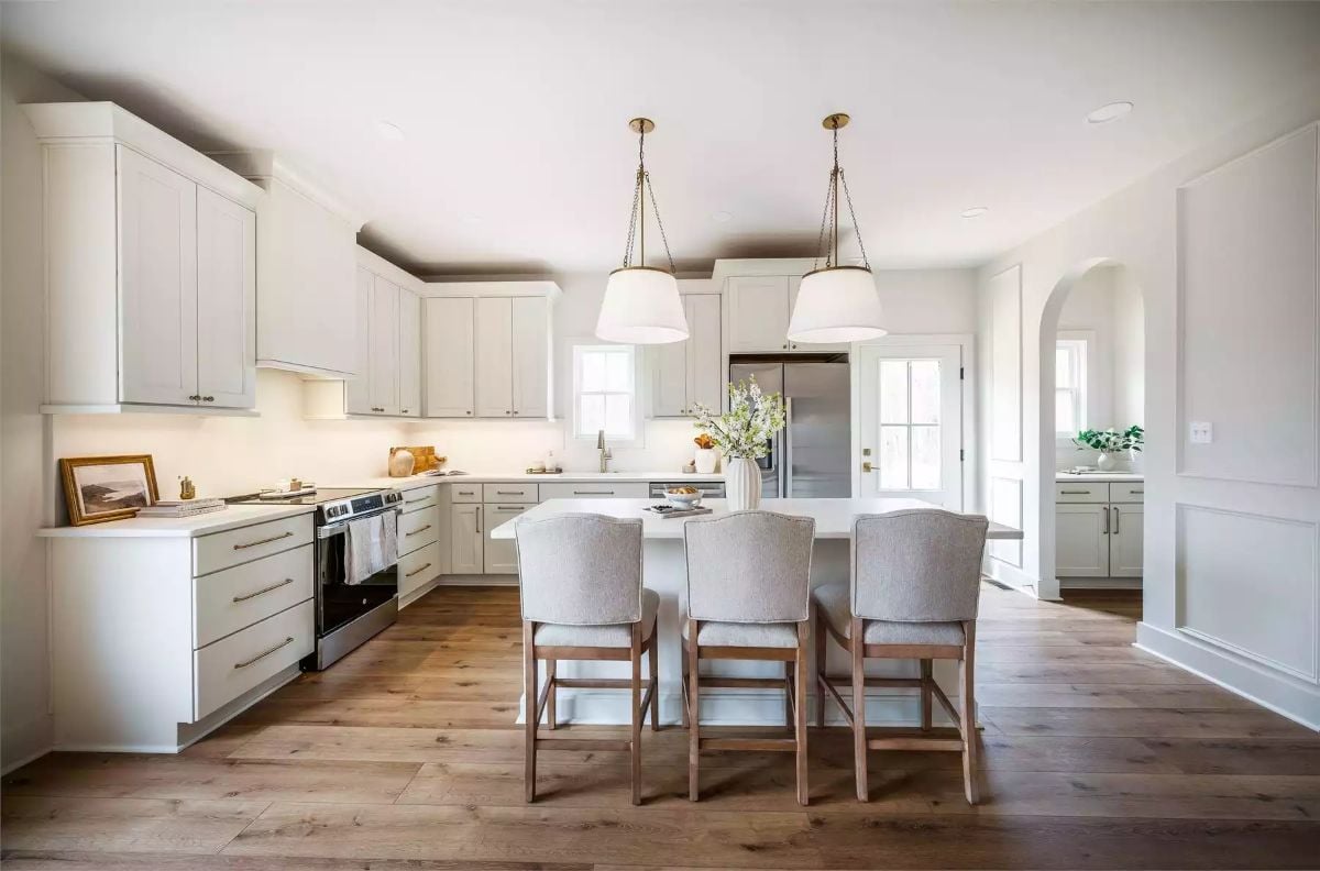 White Cabinetry and Warm Wood Floors Anchor a Kitchen Built for Daily Life