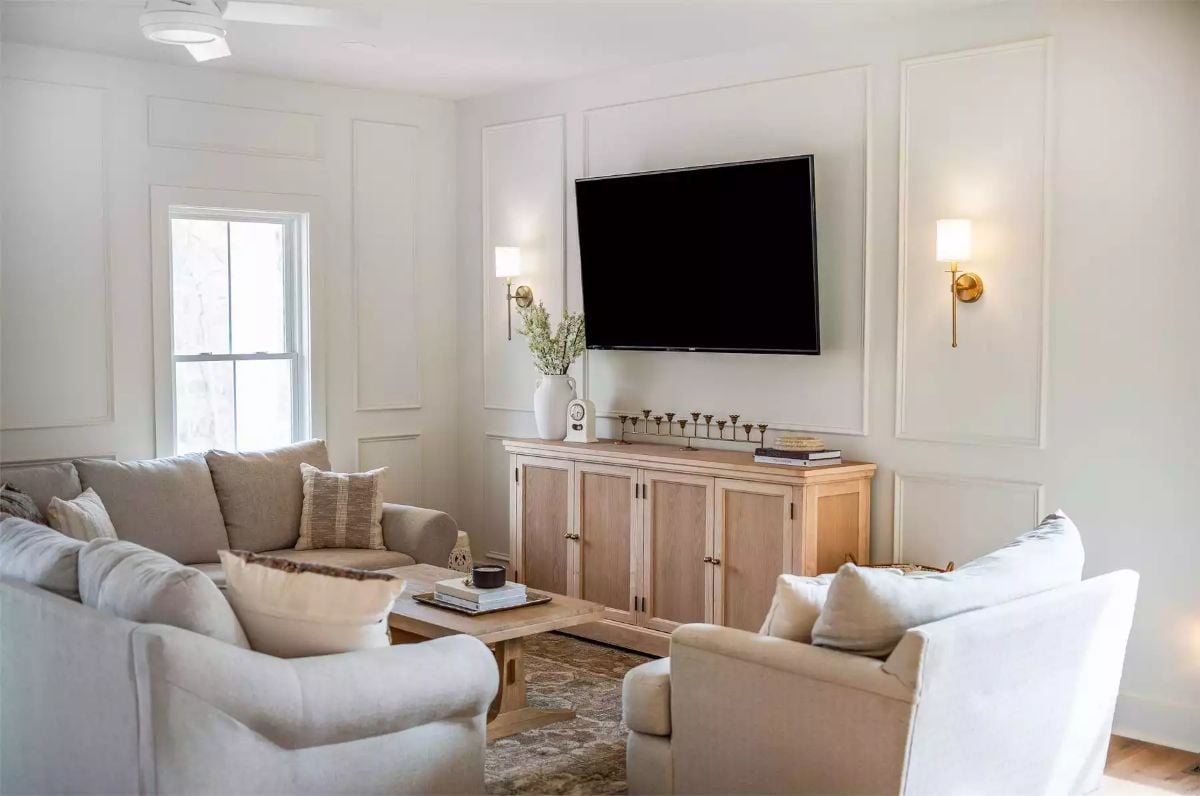 Brass Sconces and Panel Molding Give a Living Room Its Quiet Character