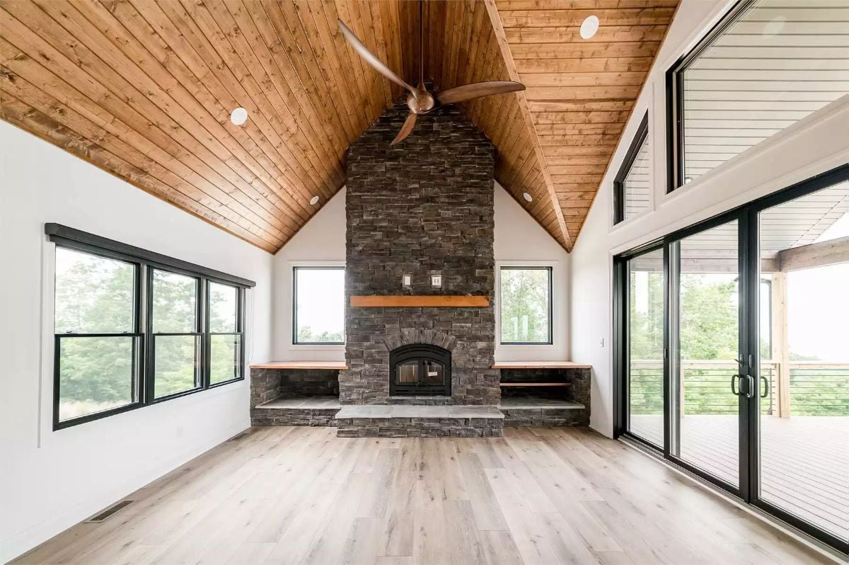 Vaulted Wood Ceiling and Stone Fireplace Define This Open Great Room