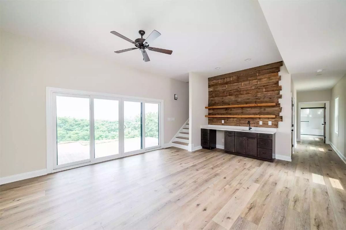 Reclaimed Wood Accent Wall Anchors an Open Living Space with Sliding Glass Access