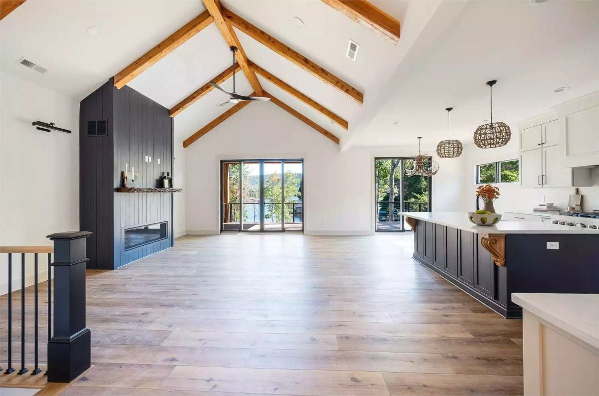 Vaulted Beams and Dark Accents Shape an Open-Plan Living Space