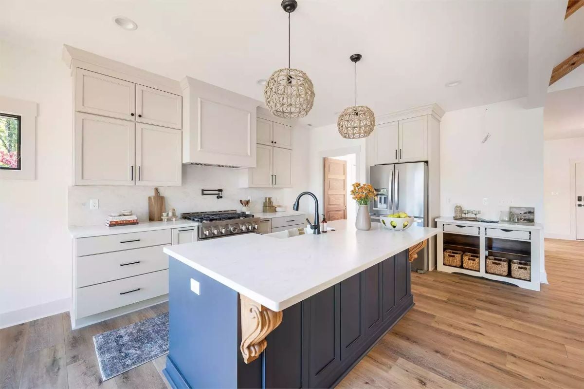 Dark Island Base and Carved Wood Corbels Ground a Bright Kitchen