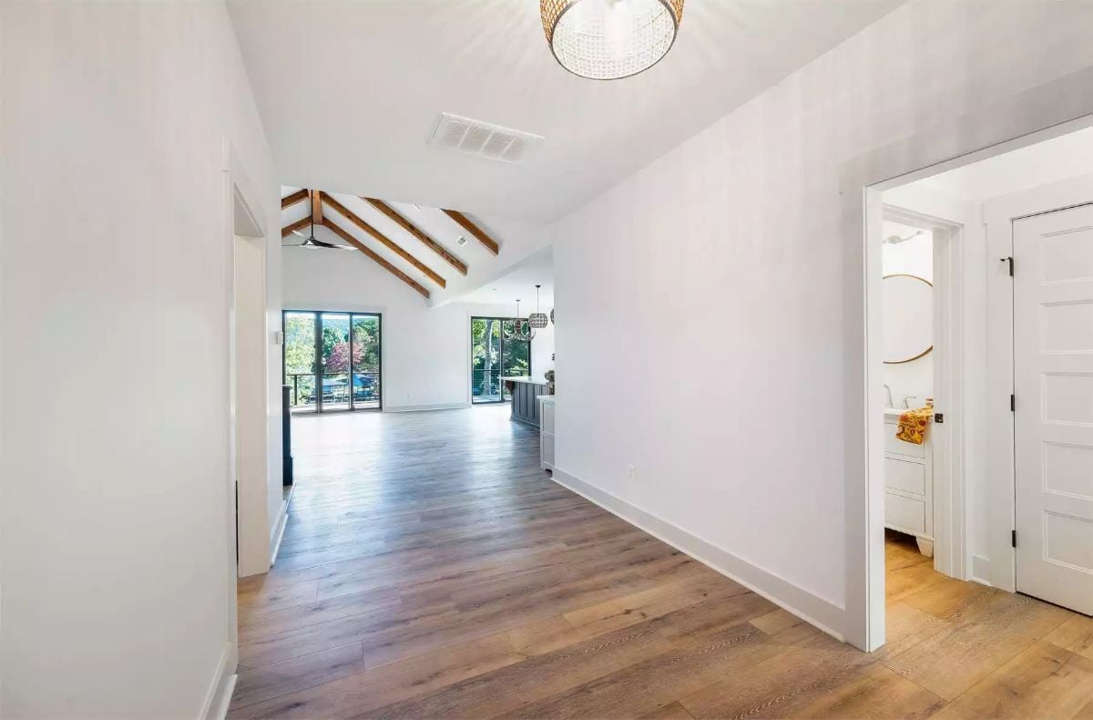 Vaulted Ceilings with Wood Beams Open Up a Sun-Filled Hallway Entry
