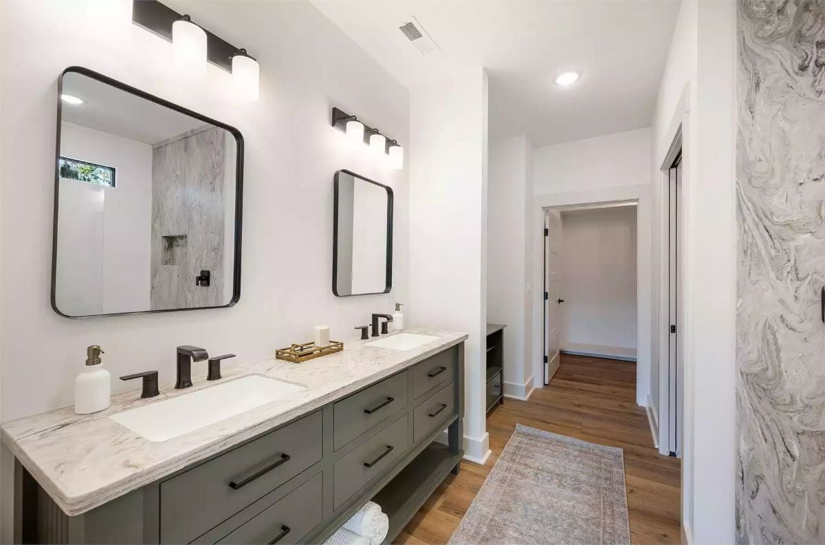 Sage Vanity Cabinets and Marble Counters Define a Double-Sink Primary Bath