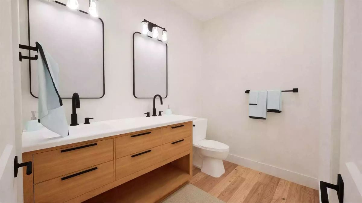 Matte Black Hardware and Wood Cabinetry Bring Warmth to a Double-Sink Bathroom