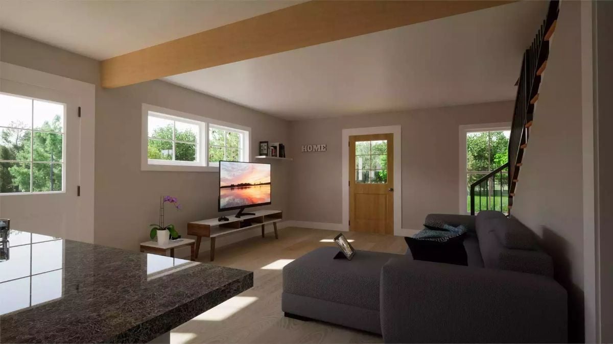 Exposed Beam, Gray Walls, and a Sunset on Screen Make This Living Room Work