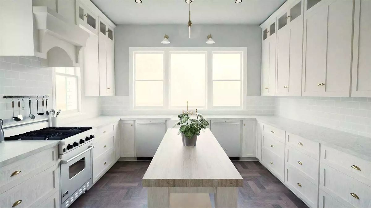 Brass Hardware and a Wood Island Counter Break the All-White Kitchen's Monotony