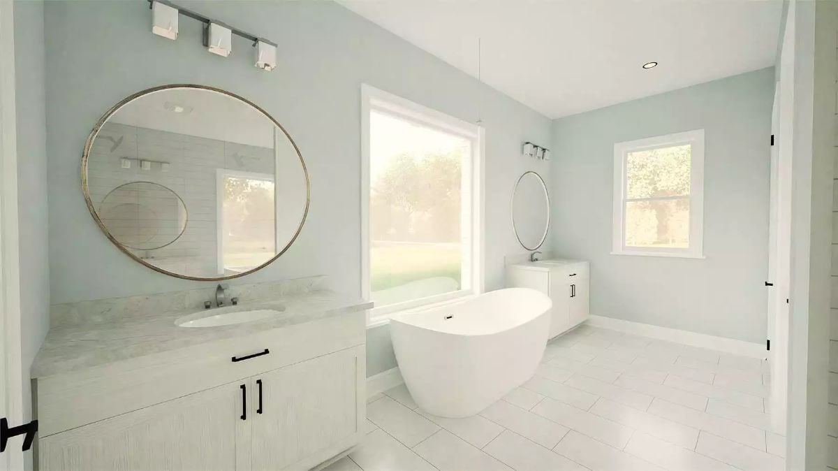 Oval Mirrors and a Freestanding Tub Keep This Primary Bath Quietly Composed