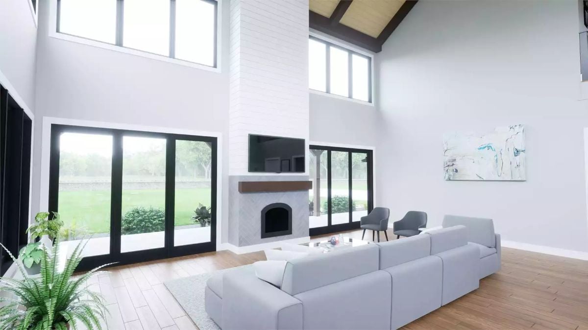 Soaring Ceilings and a Stone Fireplace Define the Heart of This Barndominium Great Room