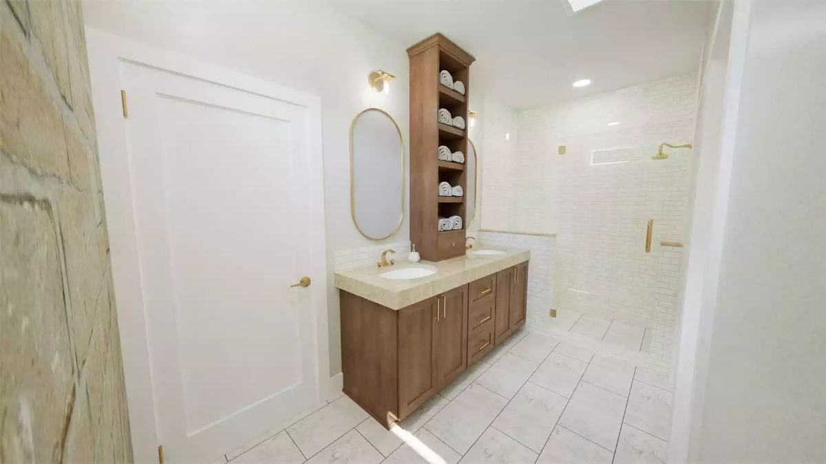 Tall Tower Cabinet Between Dual Sinks Keeps Rolled Towels Within Reach