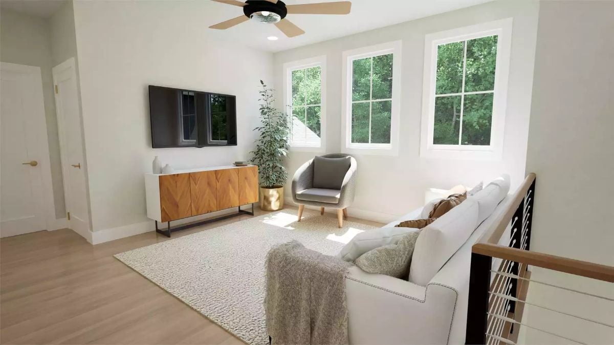 Loft Sitting Area Pairs a Wood Media Console with Rattan Accent Chair