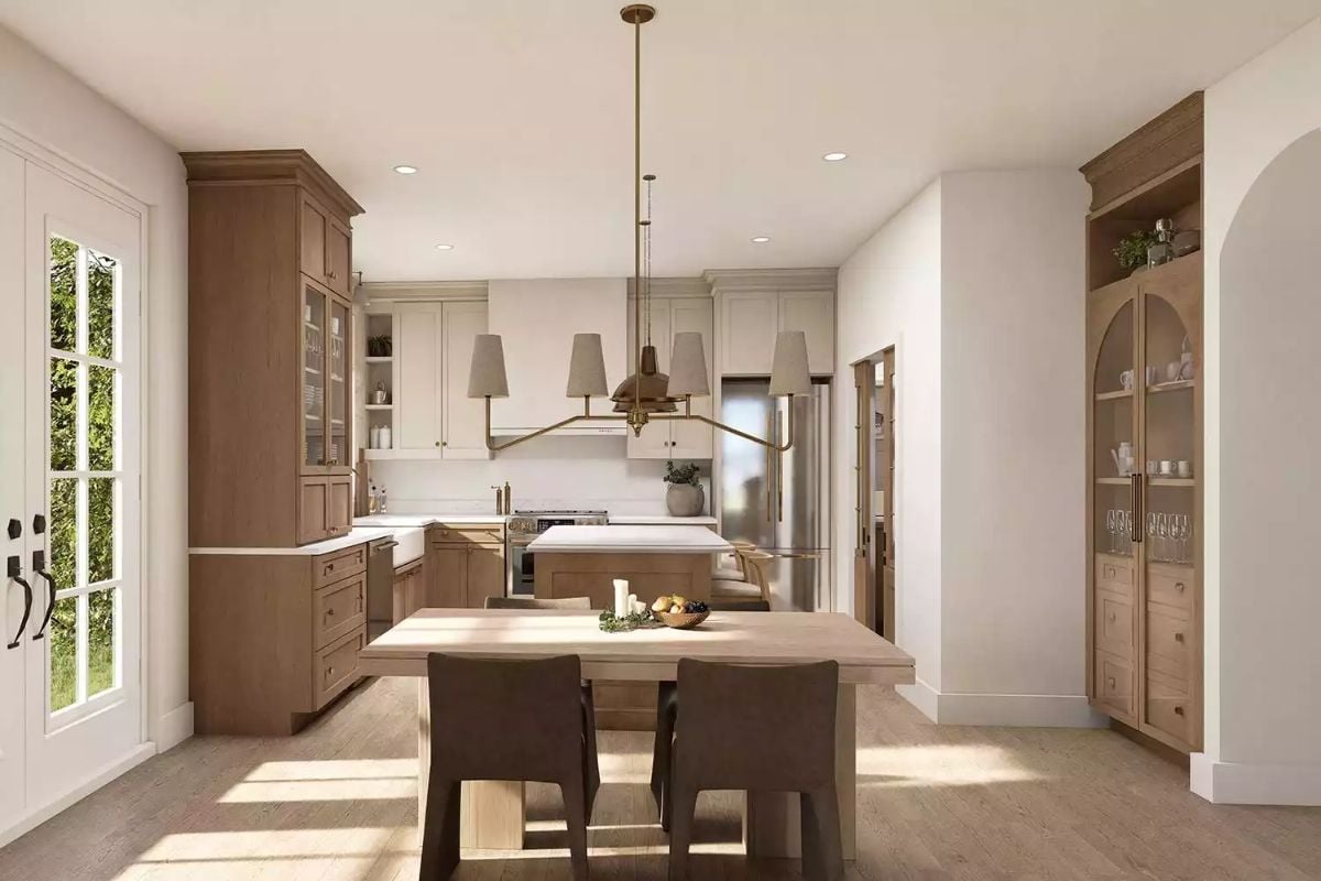 Warm Wood Tones and Brass Hardware Define an Open Kitchen Worth Cooking In