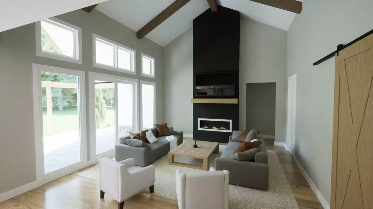 Vaulted Ceilings and a Black Fireplace Wall Set the Tone in This Living Room