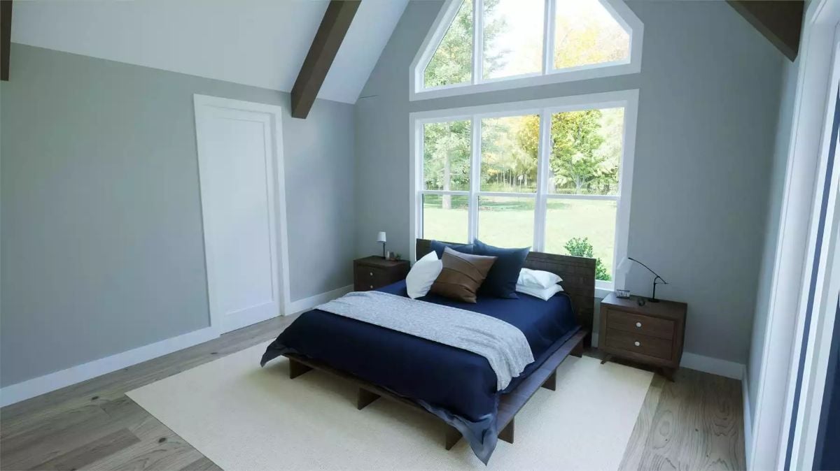 Vaulted Bedroom with Cathedral Window Frames a Green Backyard View