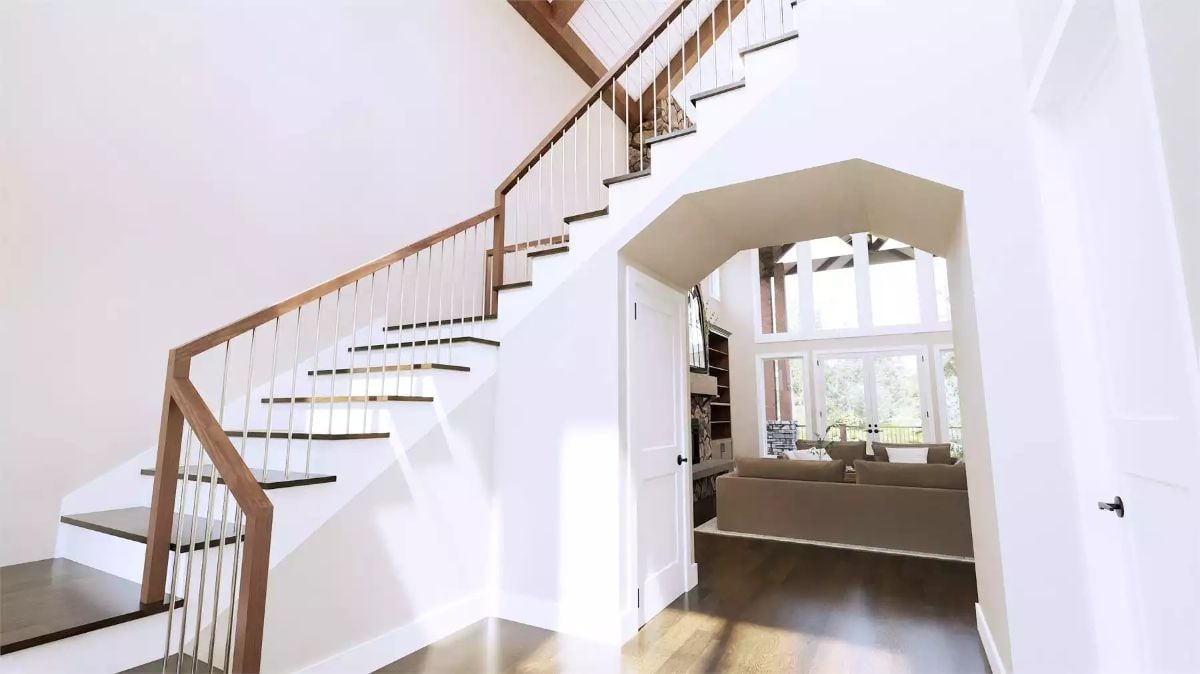 Warm Wood Railings and White Balusters Frame a Grand Staircase Entry