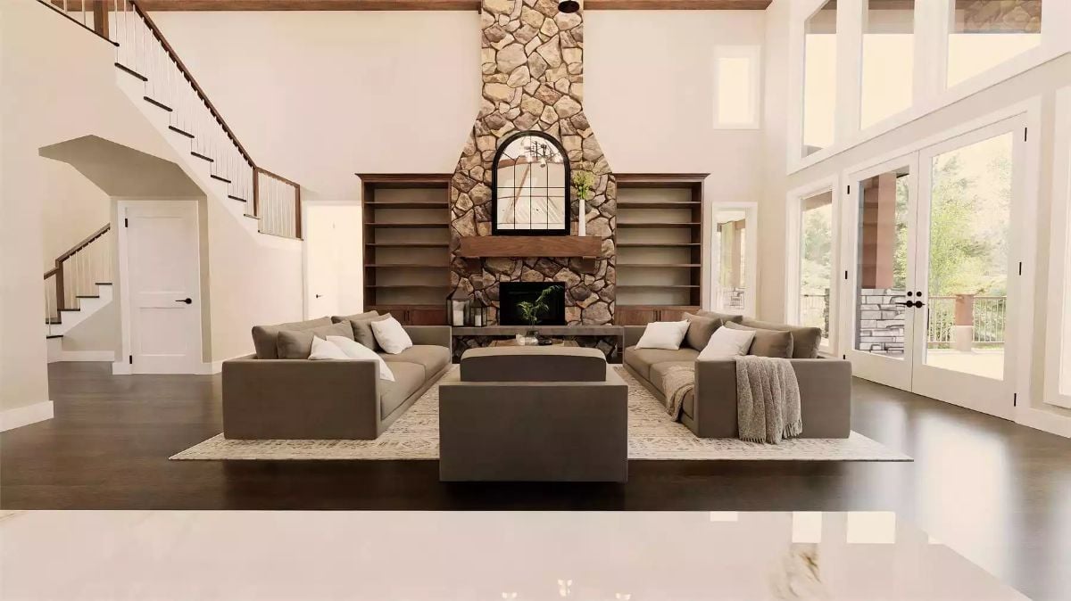 Stone Fireplace Tower and Built-In Shelves Anchor an Open Living Room