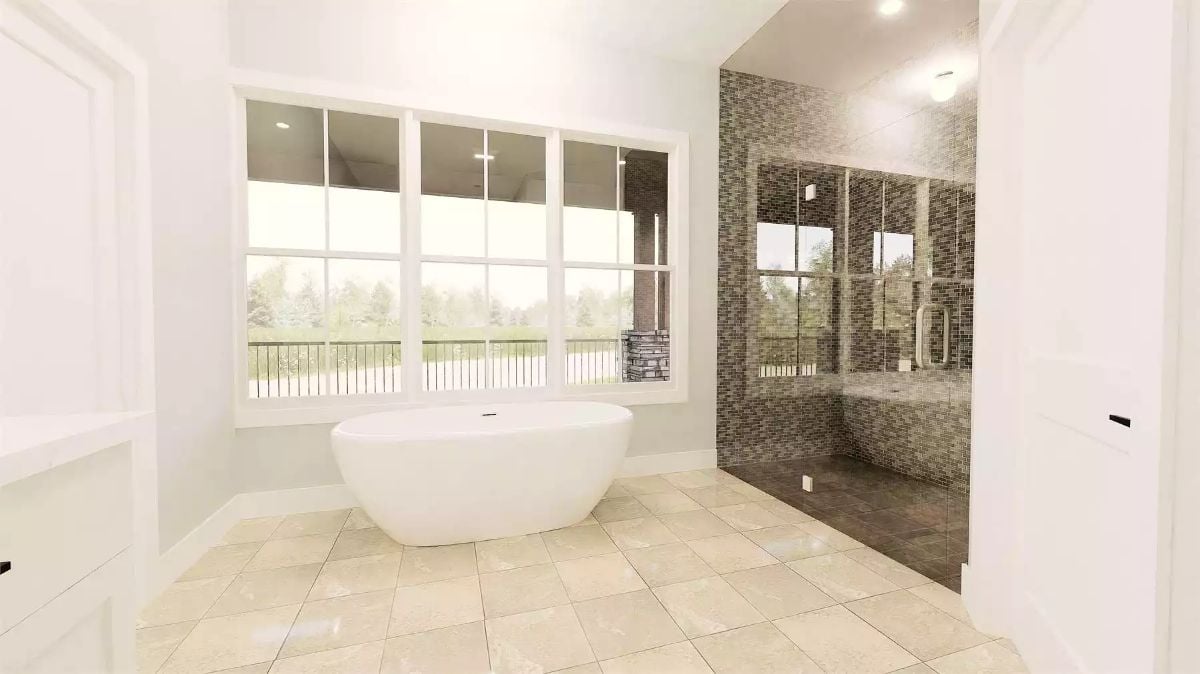 Freestanding Soaking Tub and Mosaic Tile Shower Define a Spa-Style Primary Bath
