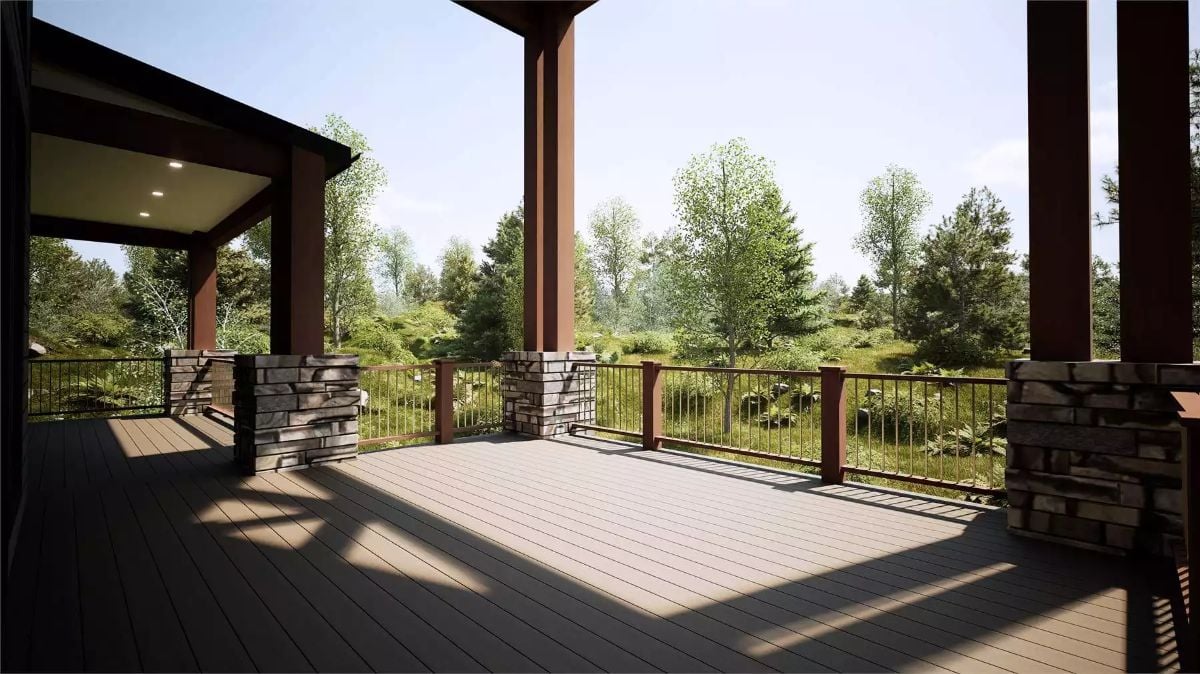 Stone Pillars and Metal Railings Wrap a Covered Deck Overlooking Wooded Grounds
