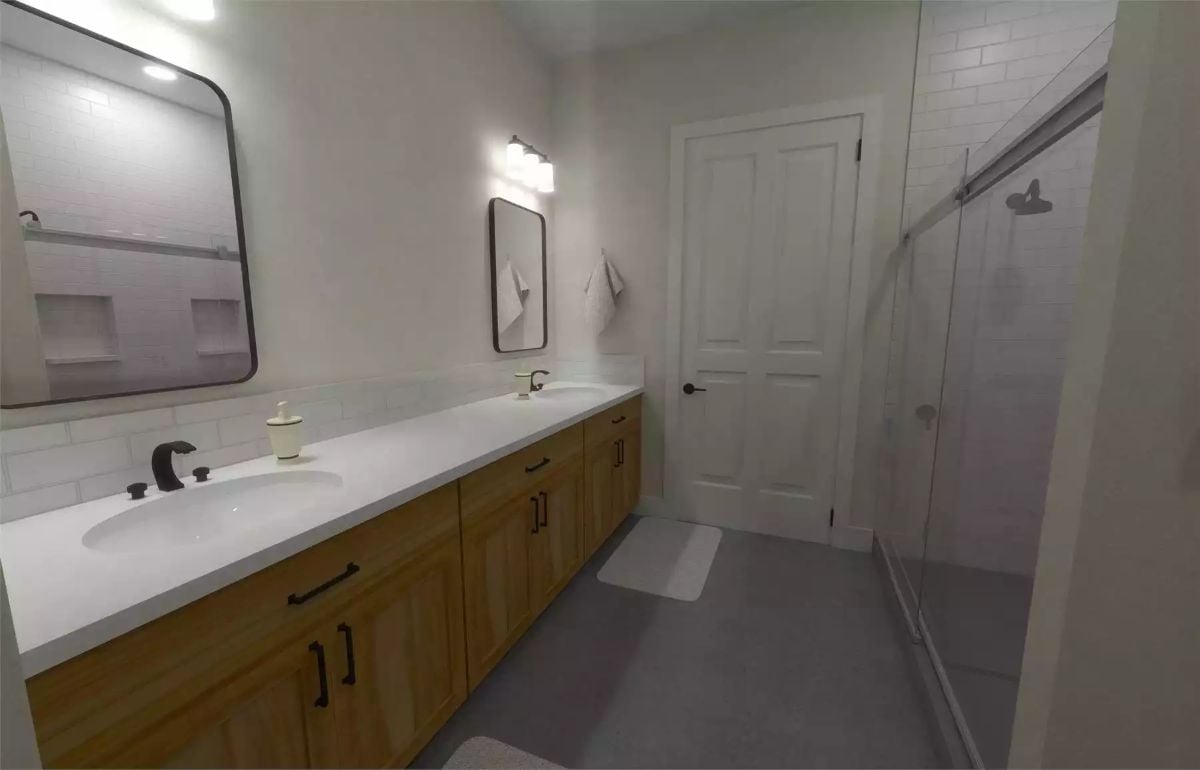 Dual Sinks, Warm Cabinetry, and a Glass Shower Make This Bathroom Work Hard