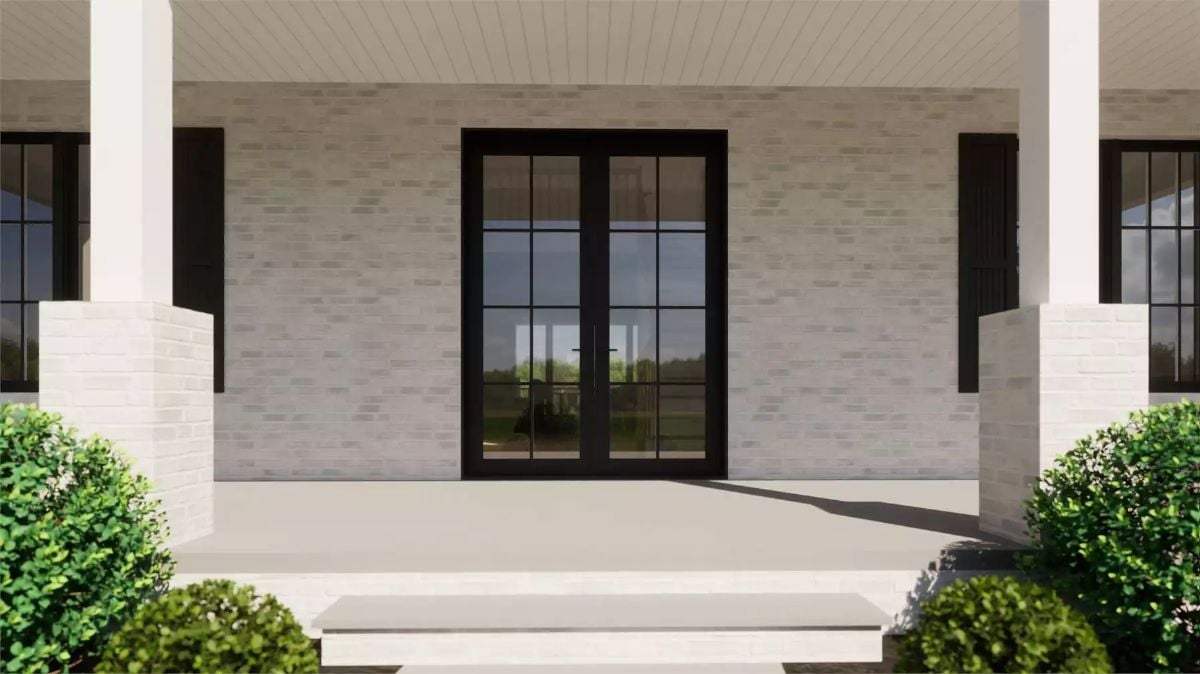 Black French Doors Anchor a Whitewashed Brick Facade on This Country Home