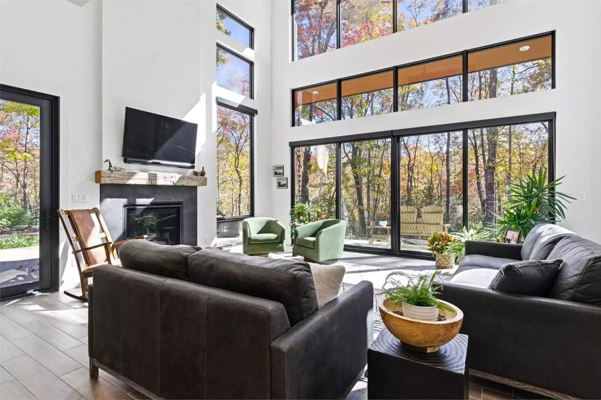 Double-Height Windows Frame Autumn Forest Views in This Carolina Great Room