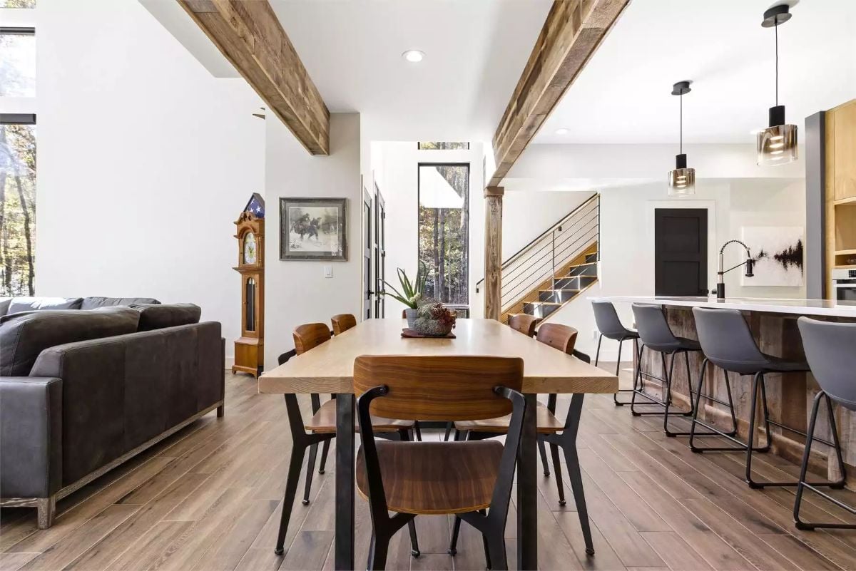 Reclaimed Beam Ceiling Anchors an Open Dining and Kitchen in Warm Wood Tones
