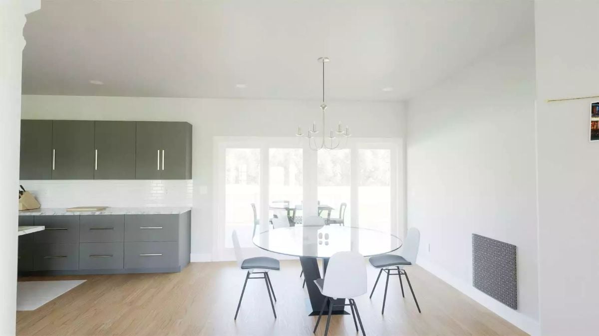 Gray Cabinets, Glass Table, and a Chandelier Over an Open Dining Space