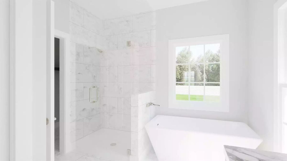 Marble Tile, a Soaking Tub, and an Open Walk-In Shower Side by Side