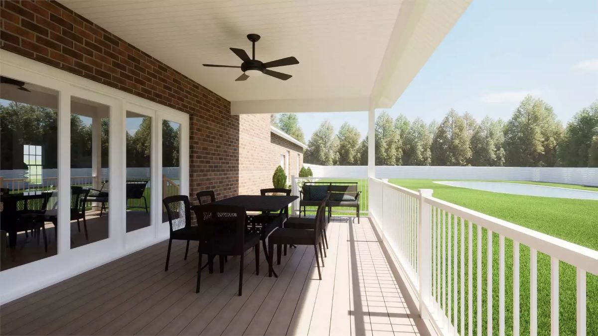 Covered Deck With Ceiling Fan, Dining Set, and a View of Open Lawn