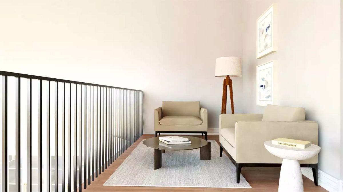 Loft Sitting Area Balances Beige Upholstery Against Black Steel Railings