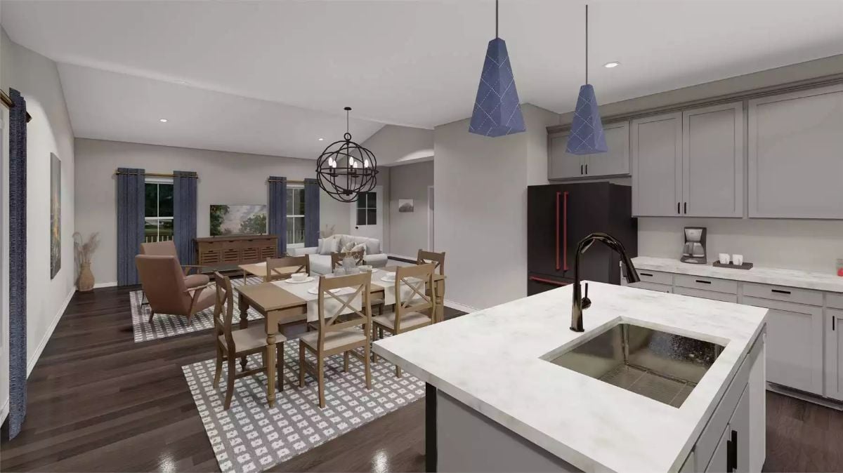 Blue Pendant Lights and Marble Island Anchor an Open Kitchen-to-Dining View