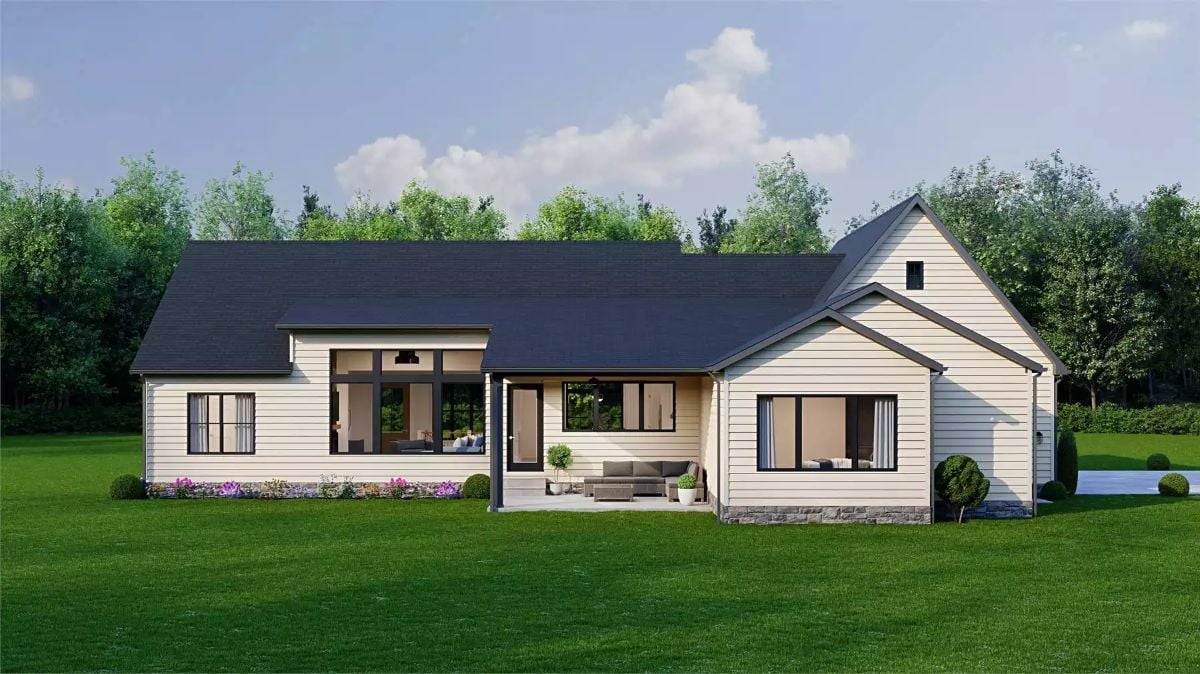 Cream Siding and Dark Trim Frame a Covered Rear Patio Built for Outdoor Living
