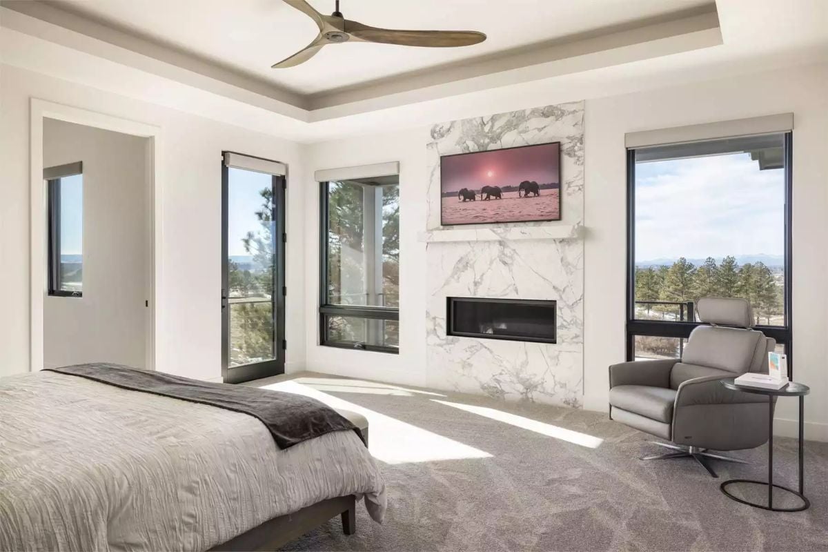 Marble Fireplace Surround and Tray Ceiling Give This Bedroom Real Presence