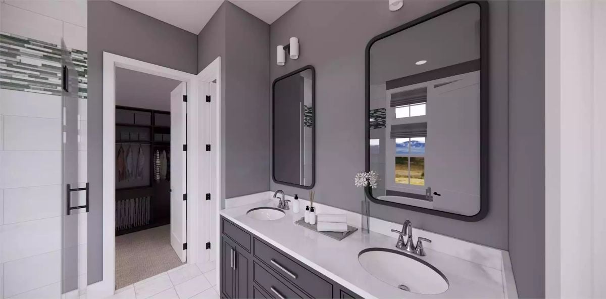 Double Vanity With Dark Cabinetry Does the Heavy Lifting in This Primary Bath