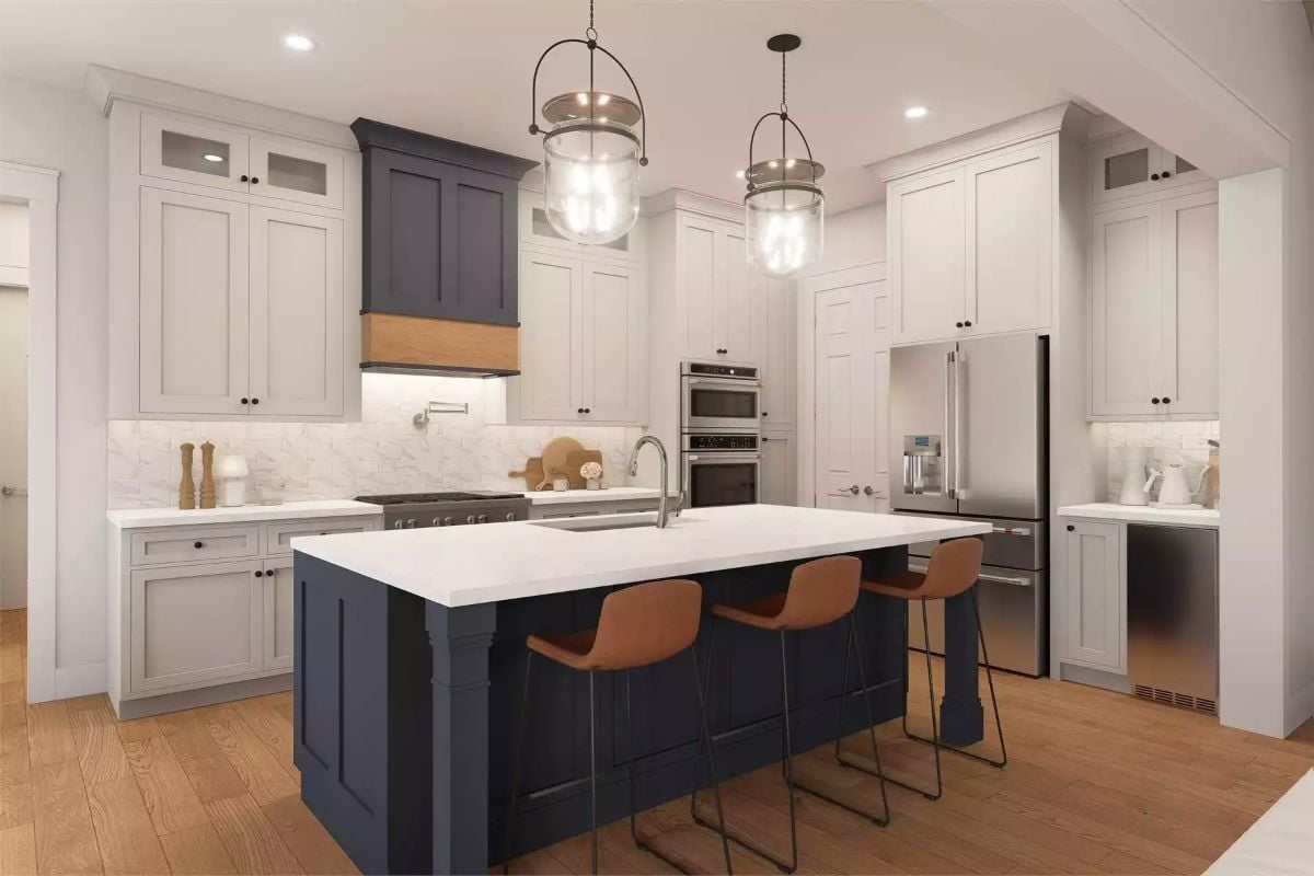 Navy Island and Pendant Lights Anchor a White Shaker Kitchen