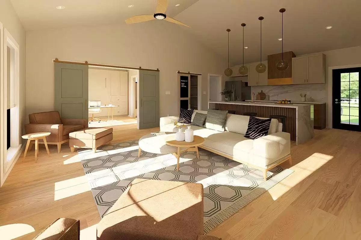 Sunlit Living Room Flows Into a Kitchen With Pendant Lights and a Bold Island