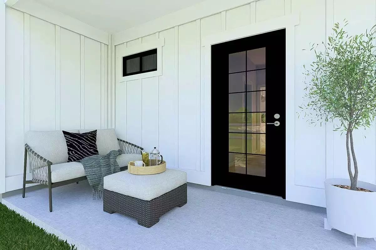 Black Grid Door and Rope-Arm Chair Set the Tone on This Covered Side Porch