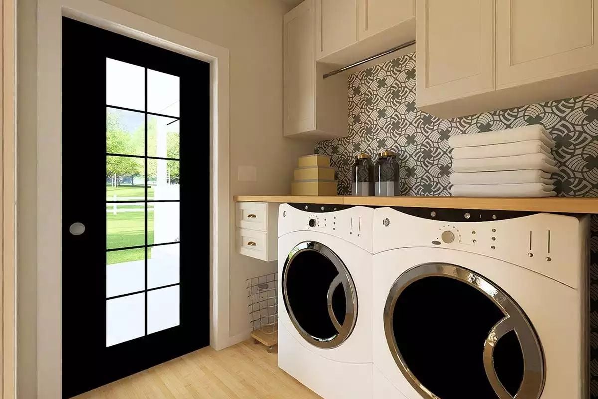 Patterned Backsplash and a Black Steel Door Make This Laundry Room Hard to Forget