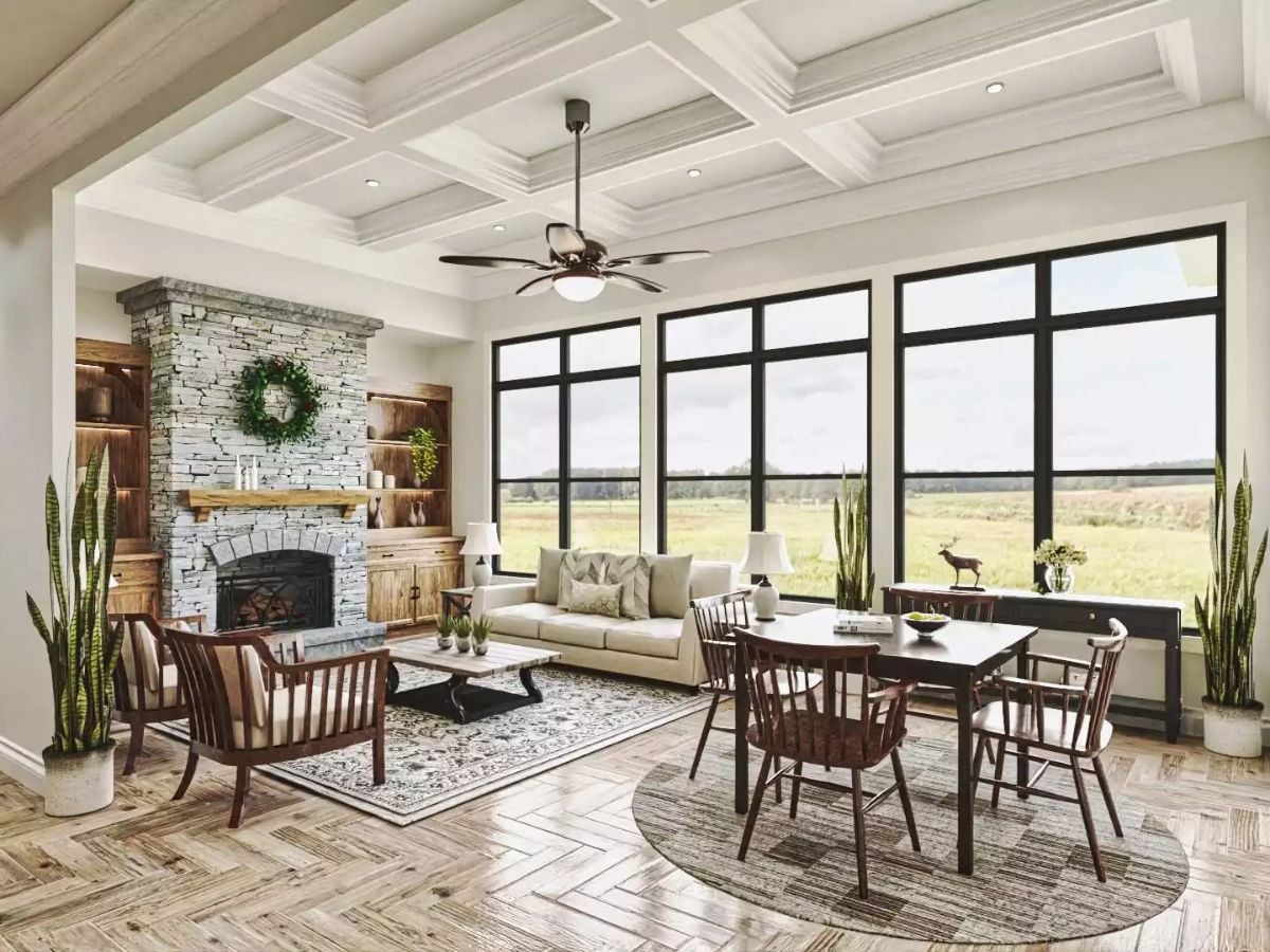 Stone Fireplace and Floor-to-Ceiling Windows Pull This Cottage Living Room in Two Directions