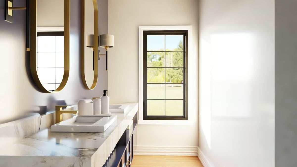 Oval Gold Mirrors and Marble Countertops Set the Tone in This Bath