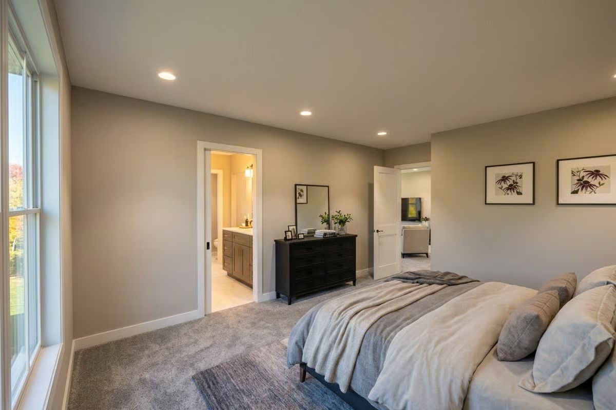 Carpeted Master Suite Opens to Ensuite Bath and a Sitting Room Beyond