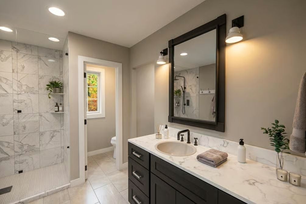 Marble Shower Wall and Dark Vanity Cabinet Pull This Bathroom Together