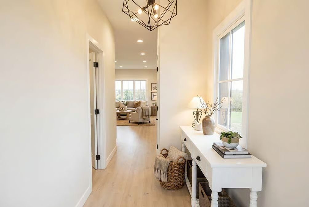 Warm Entry Hallway with Geometric Pendant and Console Table