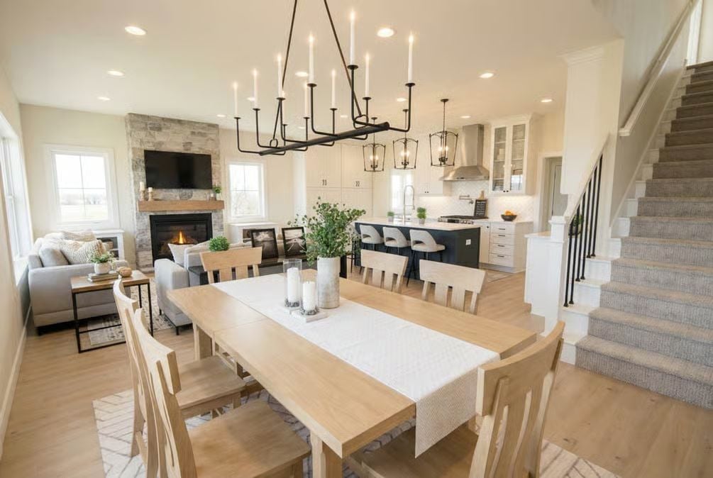 Candle Chandelier Over a Light Oak Dining Table Sets the Farmhouse Tone