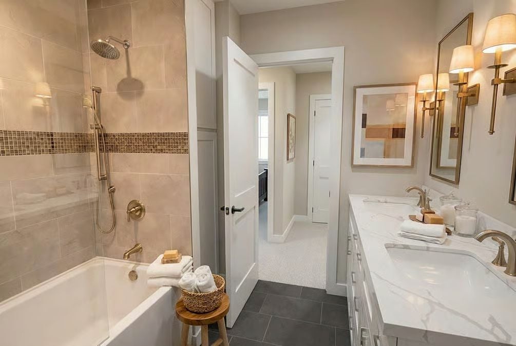Marble Vanity Top and Brass Fixtures Pull a Neutral Bathroom Together