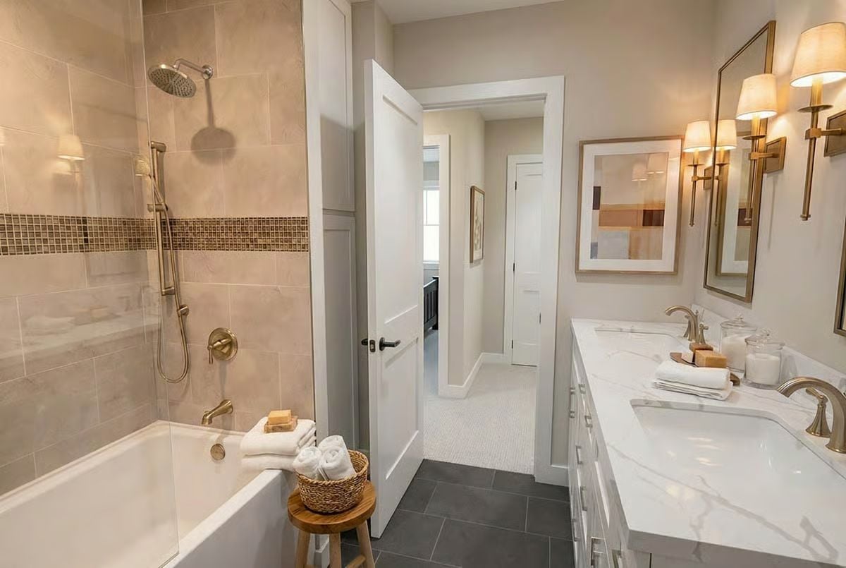 Brass Fixtures and Marble Counters Make a Narrow Bathroom Work Hard