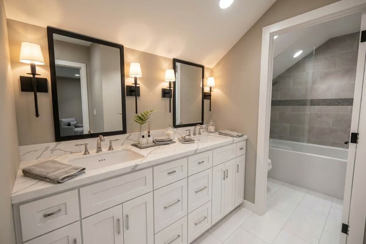 Double Vanity with Marble Countertops and Sconce Lighting Done Right
