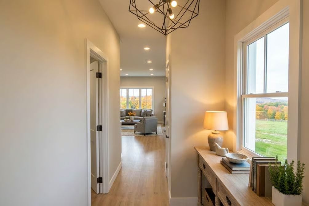 Warm Entryway Hallway with Geometric Pendant and Pastoral Views