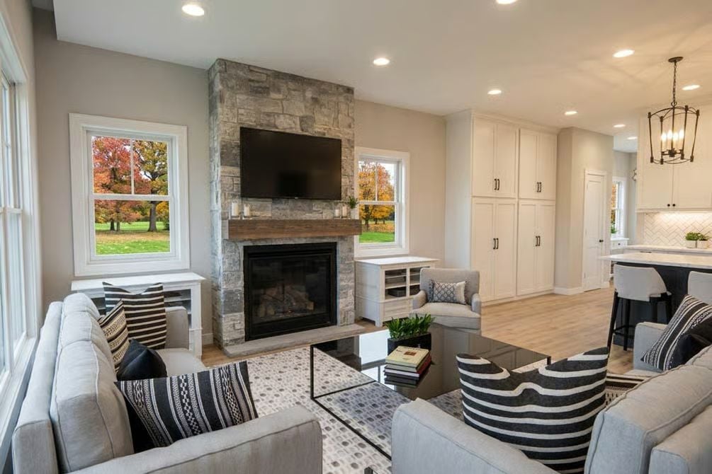 Stone Fireplace Wall and Striped Chairs Give This Family Room Its Backbone