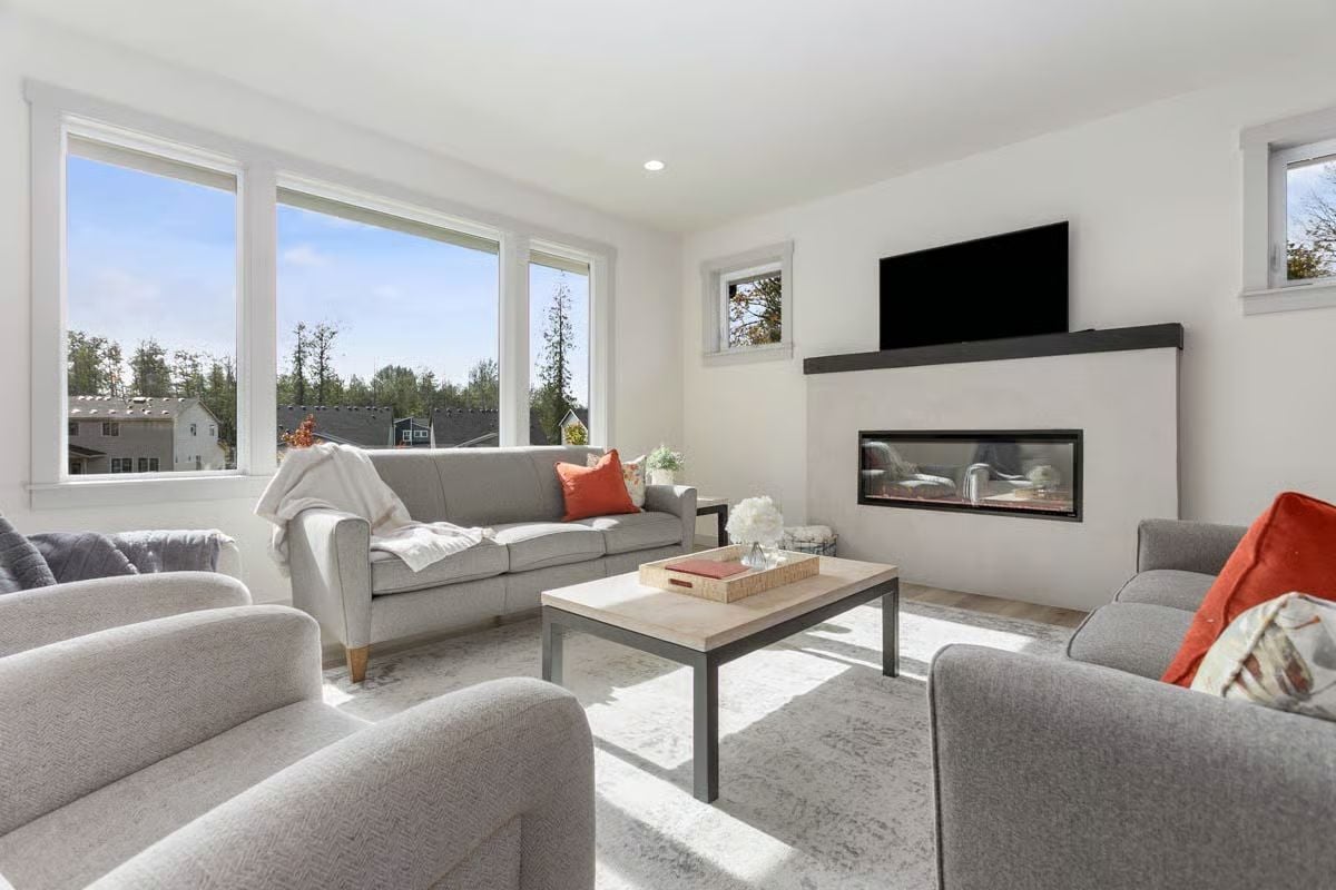 Sunlit Gray Seating Around a Linear Fireplace